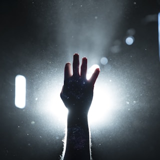 person's hand on light