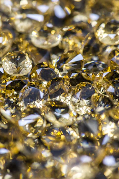 An elegant display of raw gold nuggets sparkling under natural light.
