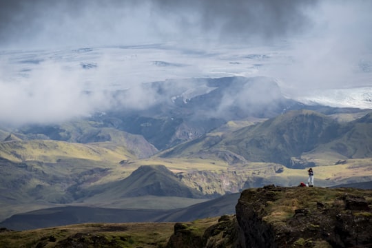aerial view of person standing on mountain in Dyrhólaey Lighthouse Iceland