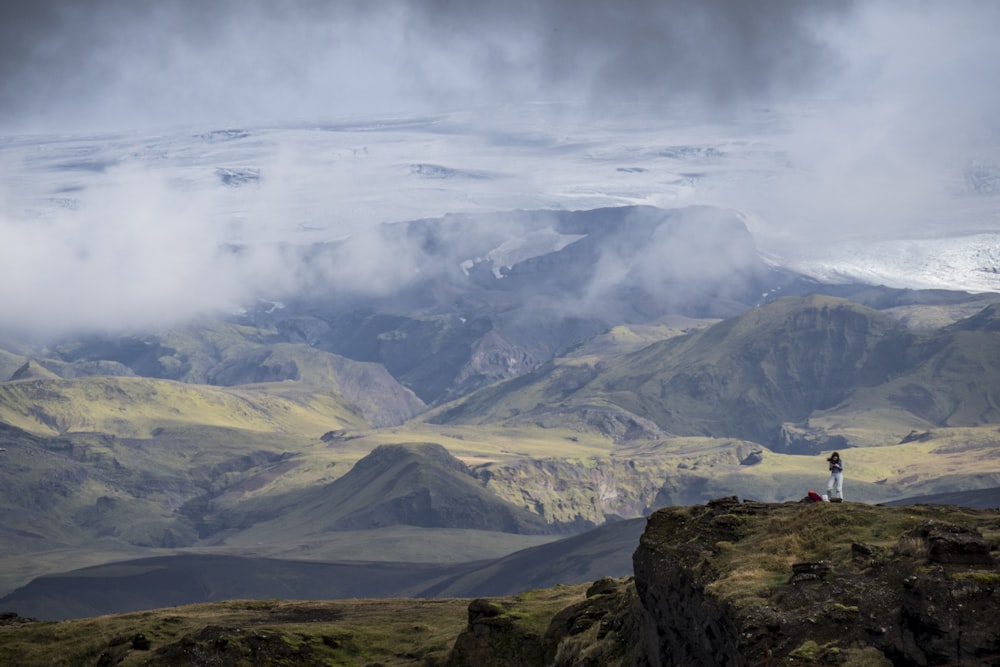 aerial view of person standing on mountain