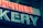 A neon sign displaying part of a word, with glowing letters in red and white. The visible letters are in a bold, sans-serif font and are mounted on a dark background. The lighting gives a vintage and somewhat retro appearance.