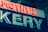 A neon sign displaying part of a word, with glowing letters in red and white. The visible letters are in a bold, sans-serif font and are mounted on a dark background. The lighting gives a vintage and somewhat retro appearance.