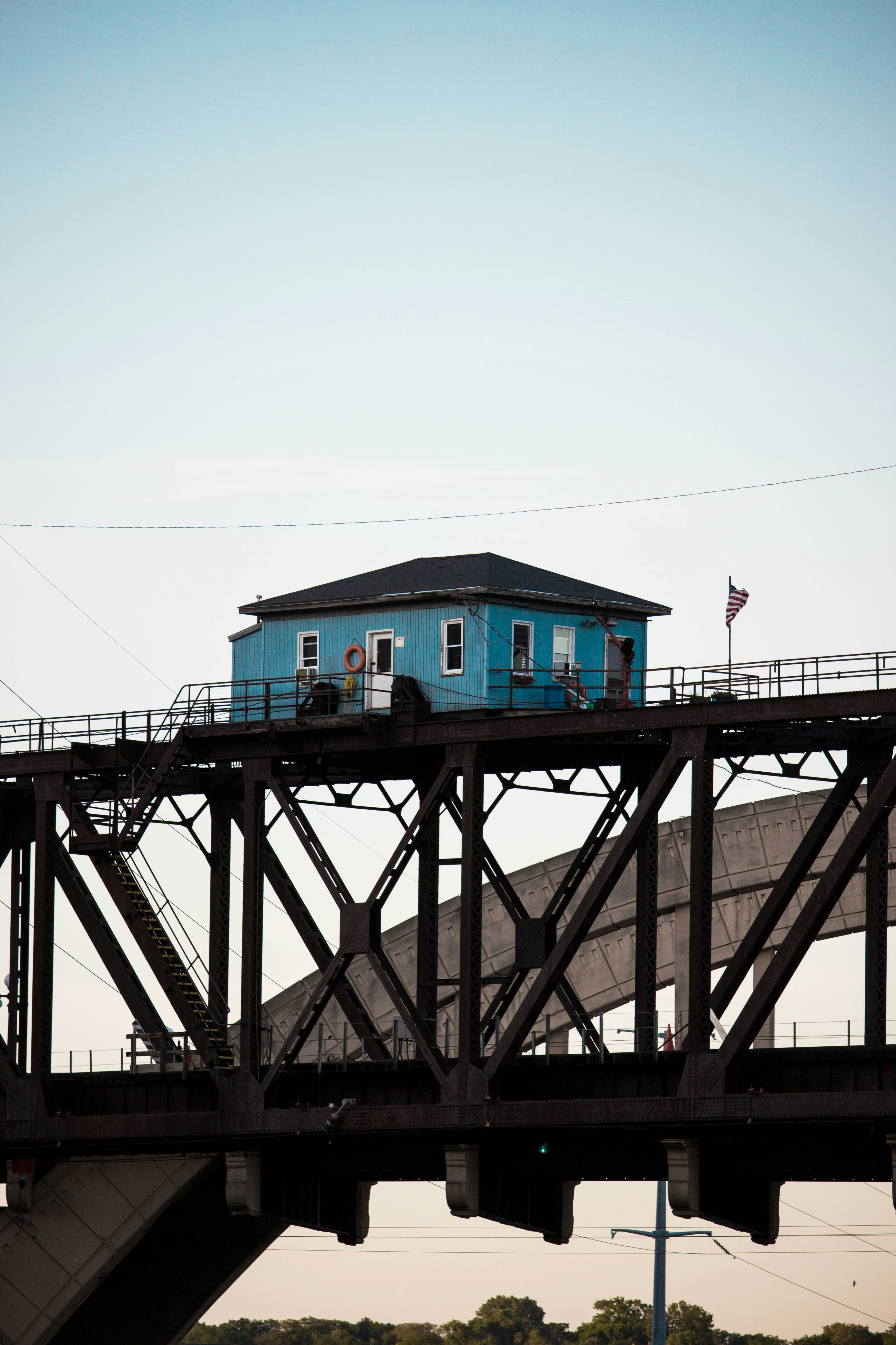 blue wooden house above bridge
