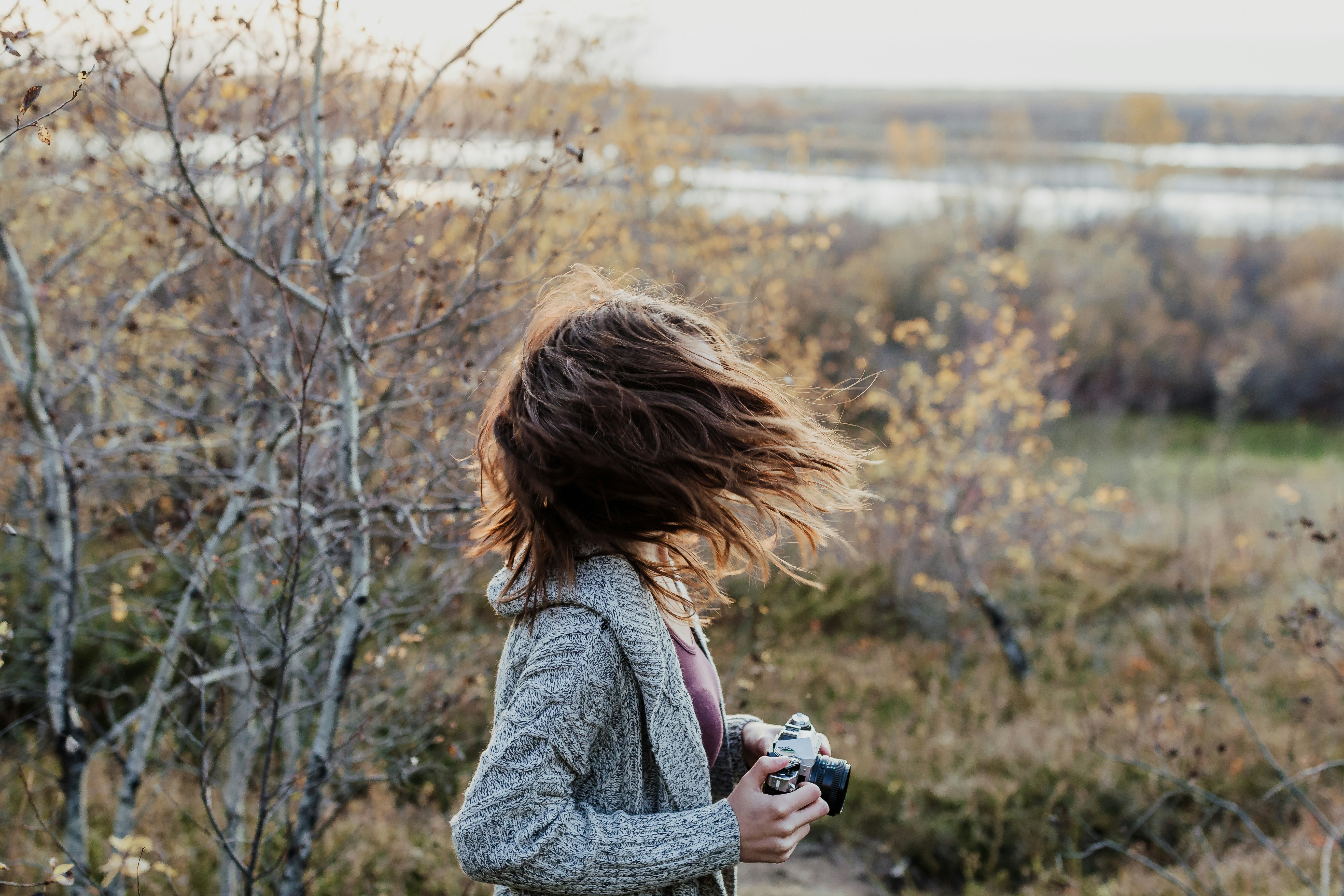 photo of woman waving her hair while holding camera cranberry sauce teams background