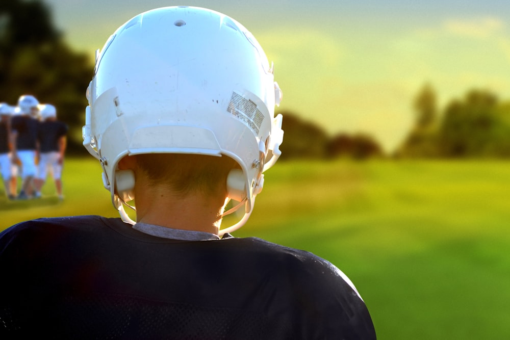 person wearing NFL helmet during daytime