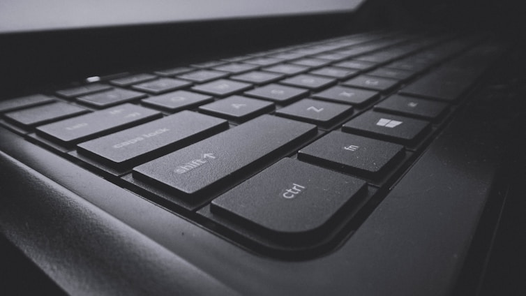 A close-up view of a black computer keyboard displaying several keys in focus, including shift, ctrl, and windows keys. The image emphasizes the texture and design of the keys with a slightly dark and moody atmosphere.