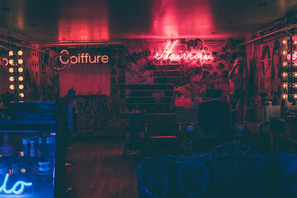 a dark room with neon lights and a neon sign