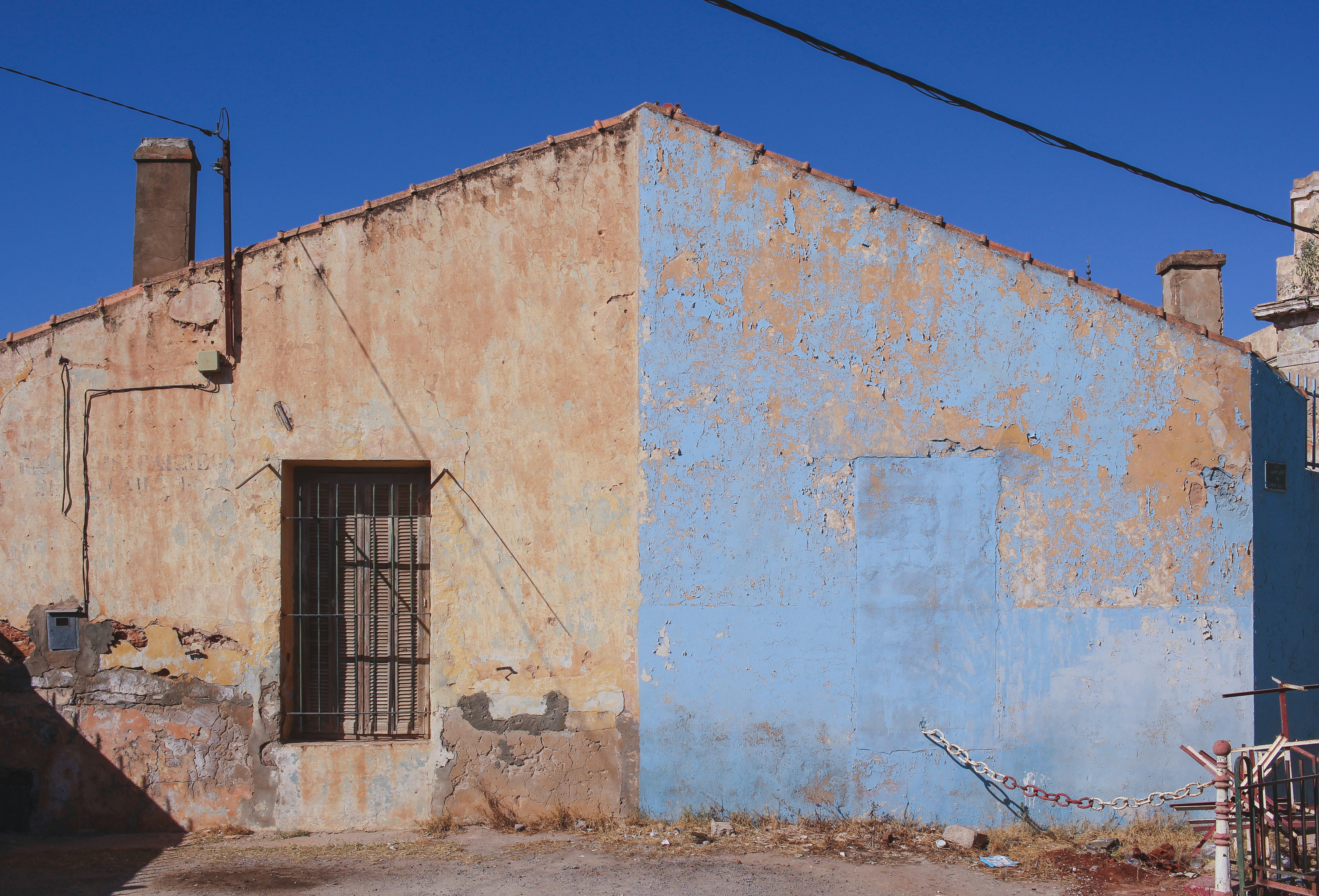 white and gray concrete building at daytime chimney teams background