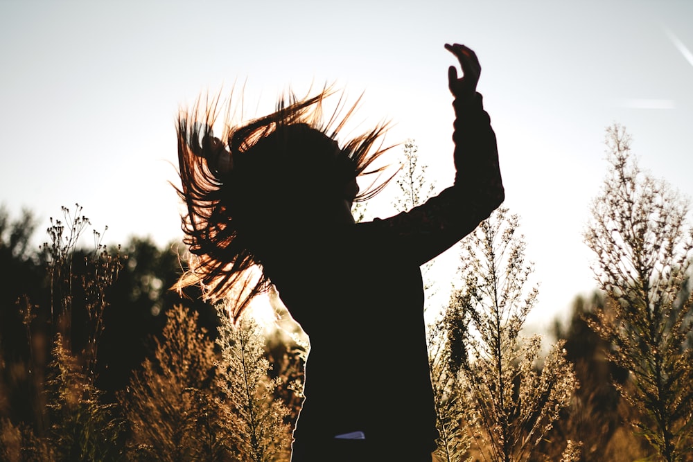 silhouette of person surrounded by plants