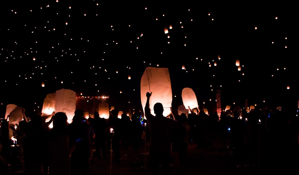 group of people holding lanterns