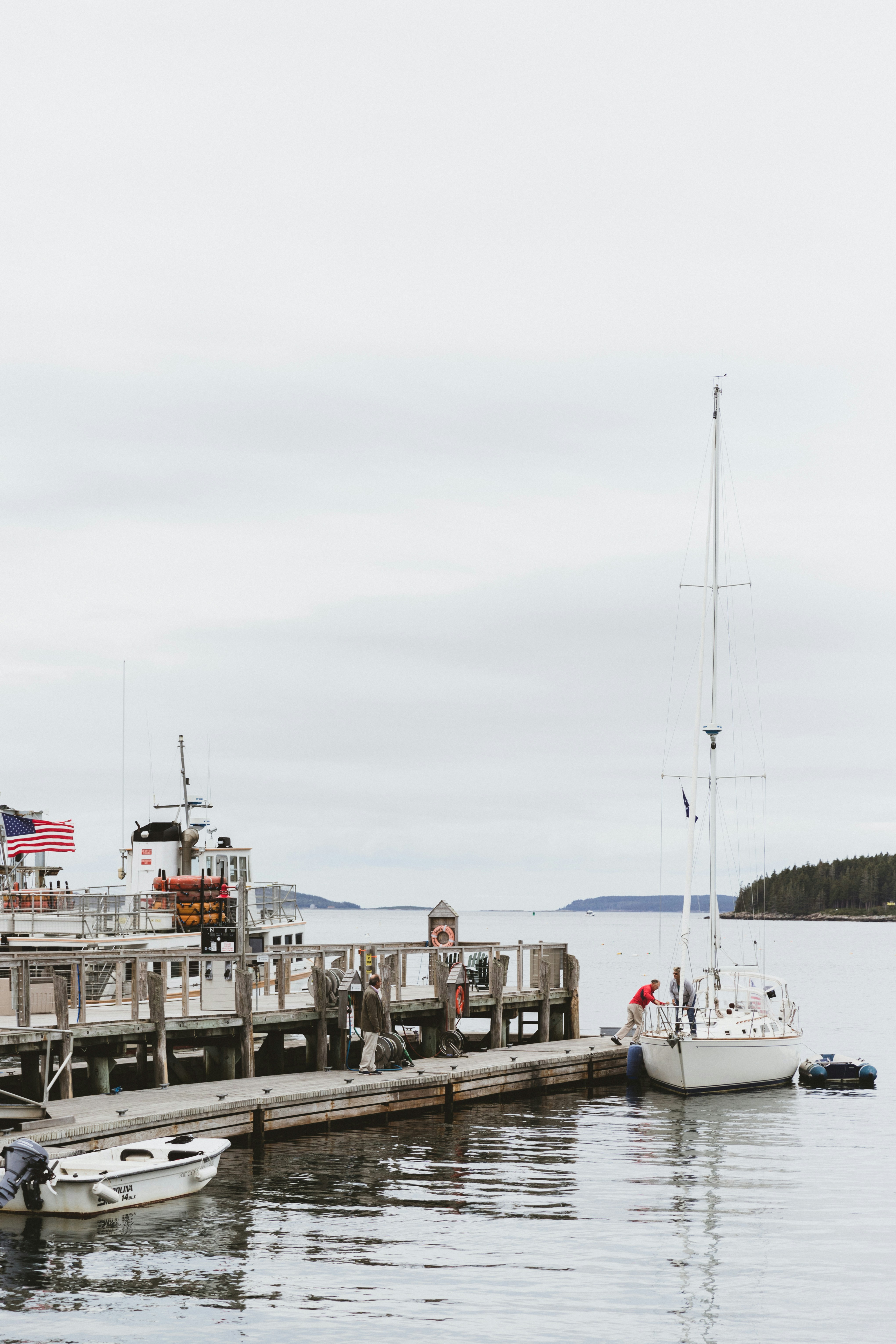 photo of a fishing vessel near on the concrete floor