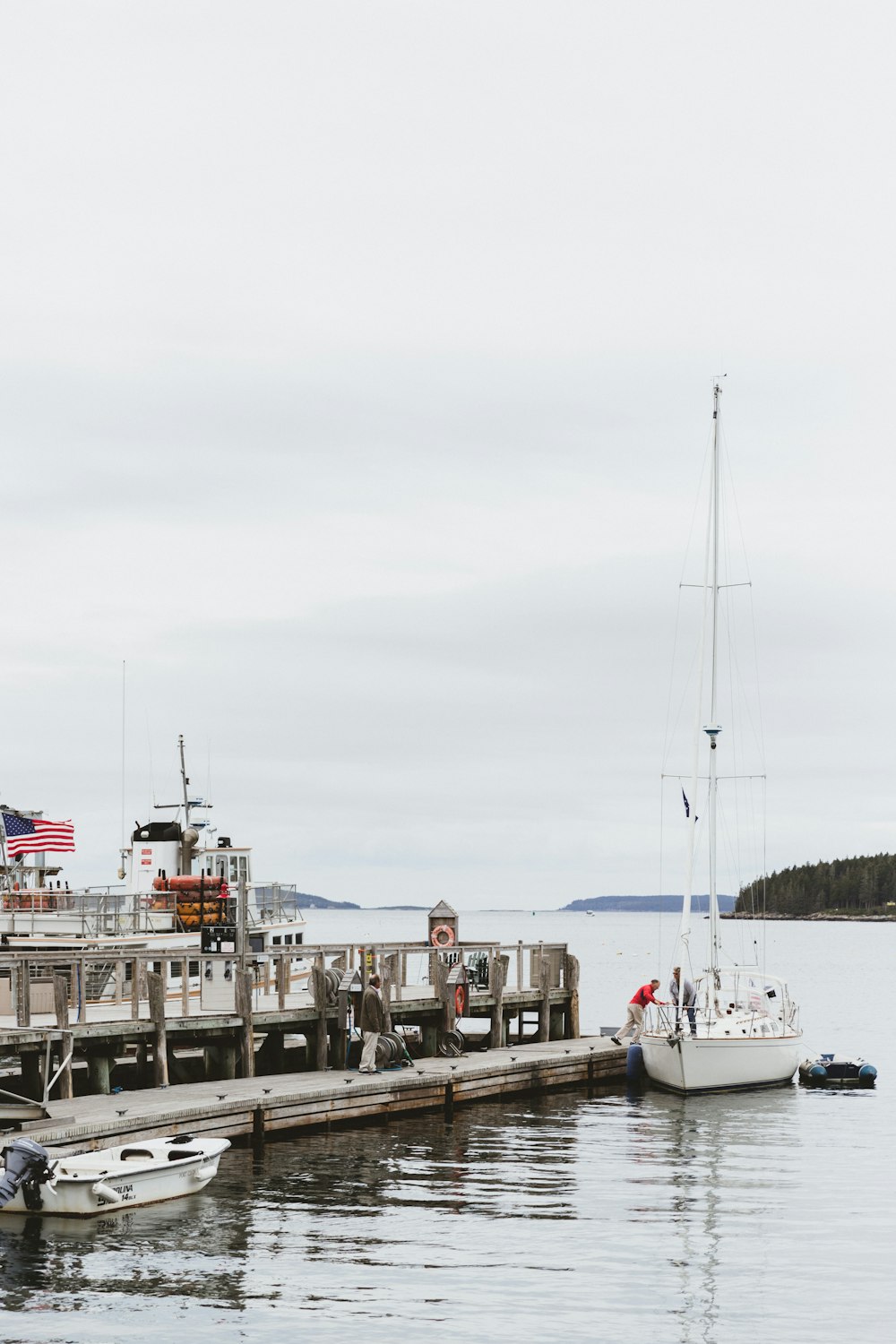 photo of a fishing vessel near on the concrete floor