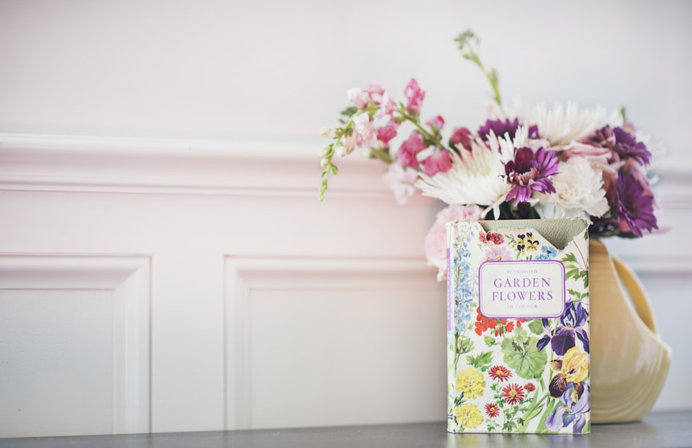 Garden Flowers book beside flower arrangement in vase