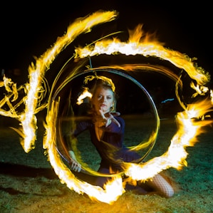 woman kneeling on ground with fire effect