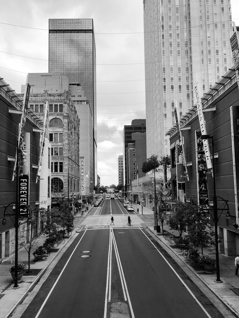 grayscale photo of high-rise buildings near road