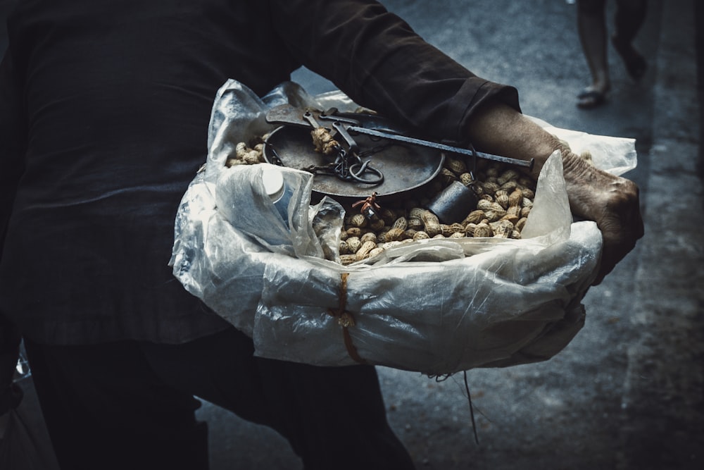 person holding bunch of peanut