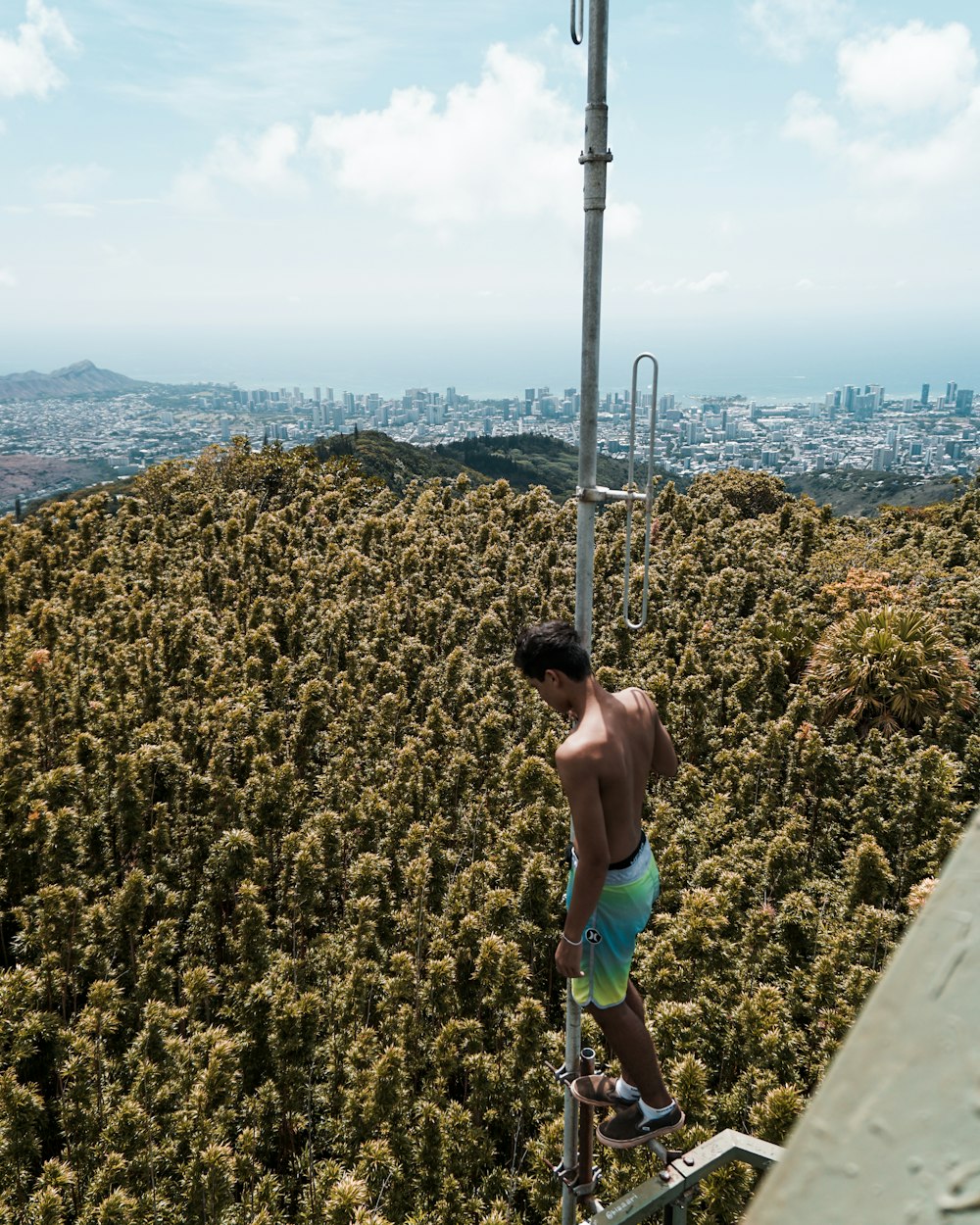 high angle photography of man standing on gray metal tube