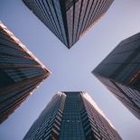 low-angle photography of four high-rise buildings