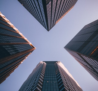 low-angle photography of four high-rise buildings