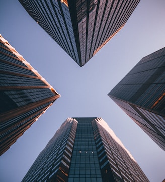 low-angle photography of four high-rise buildings