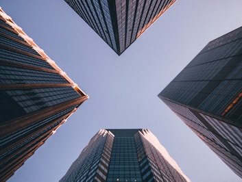 low-angle photography of four high-rise buildings