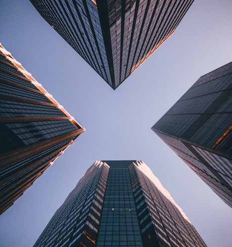 low-angle photography of four high-rise buildings