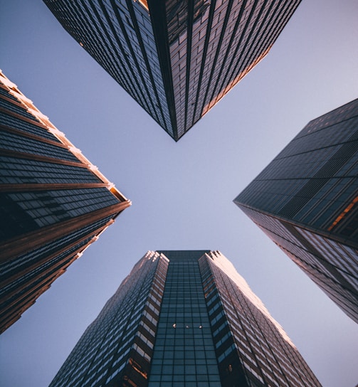 low-angle photography of four high-rise buildings