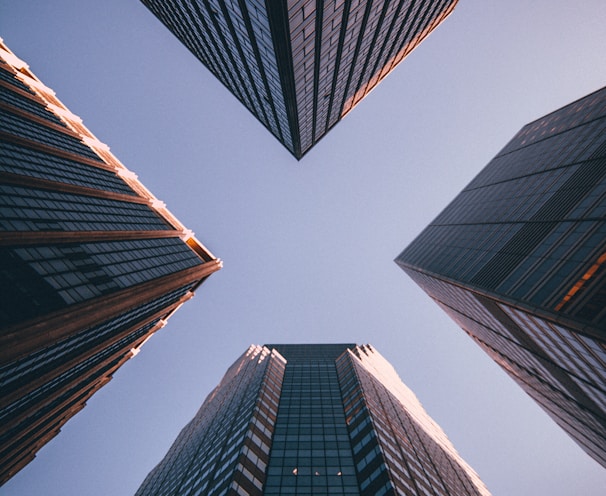 low-angle photography of four high-rise buildings