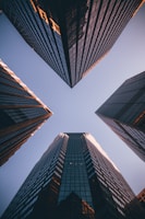 low-angle photography of four high-rise buildings
