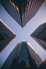 low-angle photography of four high-rise buildings