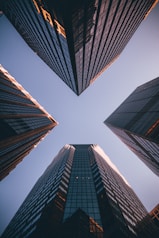 low-angle photography of four high-rise buildings