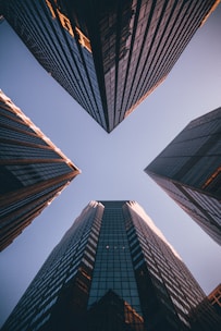 low-angle photography of four high-rise buildings