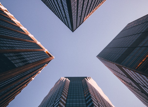 low-angle photography of four high-rise buildings