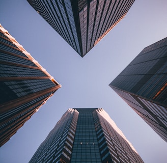 low-angle photography of four high-rise buildings