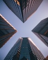 low-angle photography of four high-rise buildings