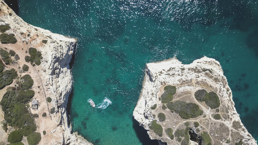 aerial photography of rock formation mountain near sea