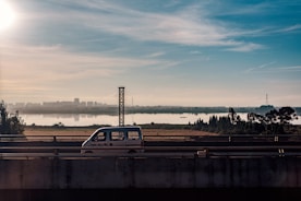 A comfortable travel van driving along a scenic highway