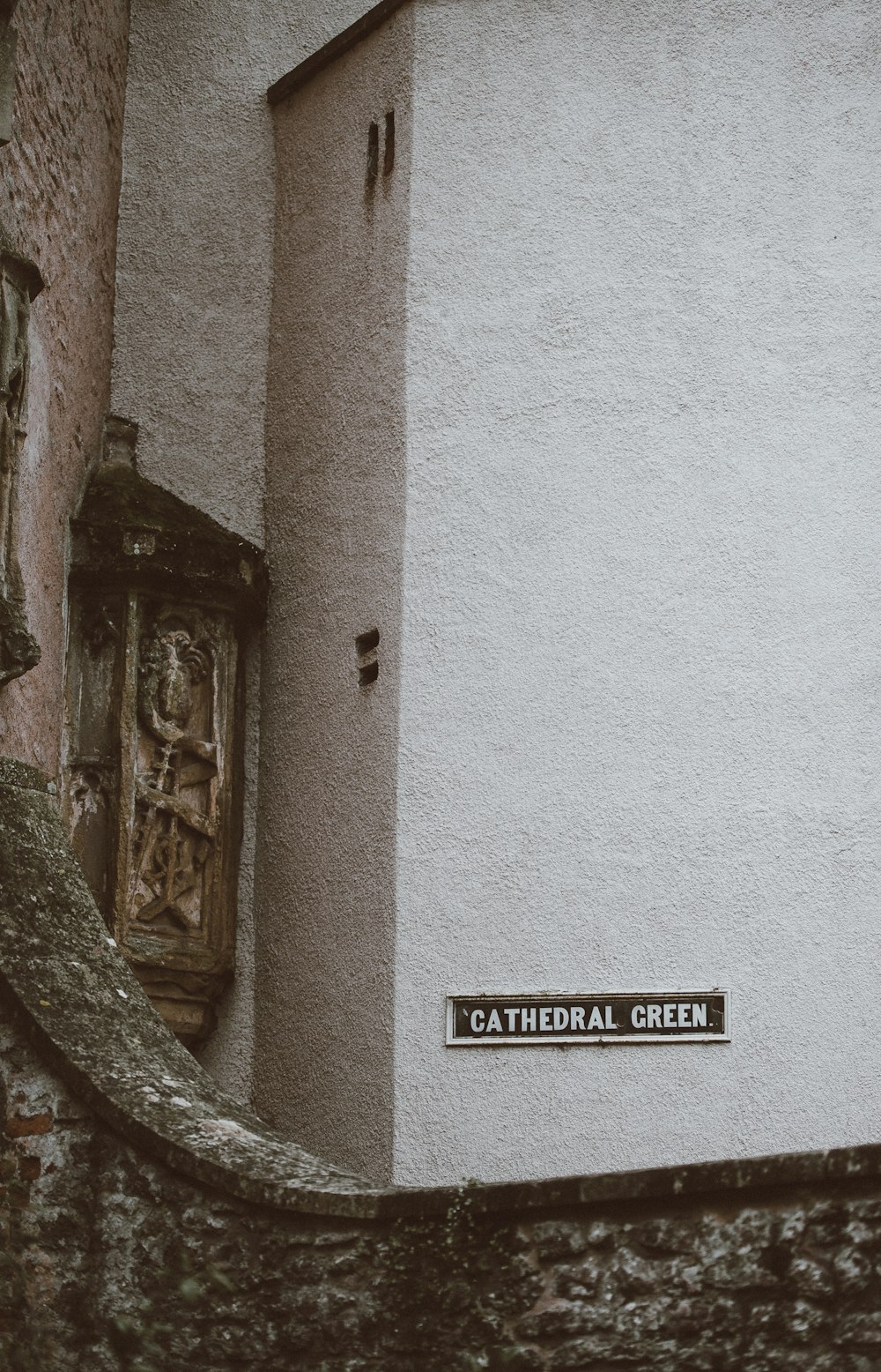 Cathedral Green signage near white wall