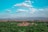A vibrant landscape of Yucatán featuring lush greenery and ancient ruins under a clear blue sky.
