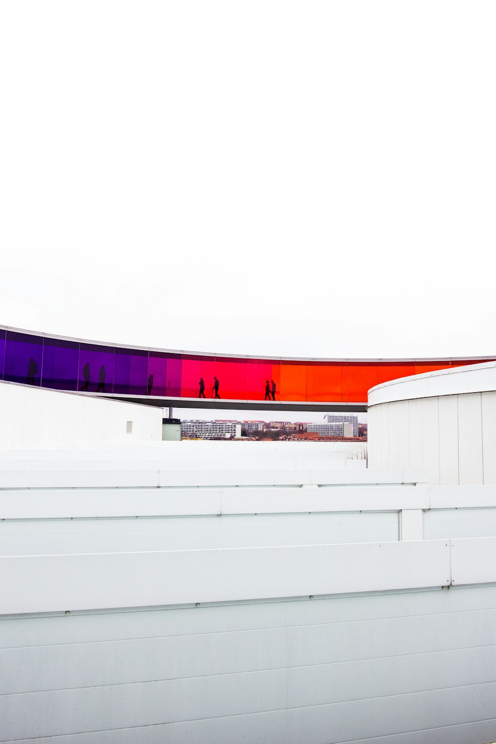 a man riding a skateboard on top of a white fence