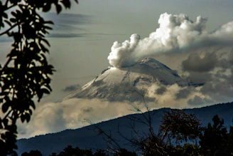 time lapse photography of mountain with smoke on its mouth