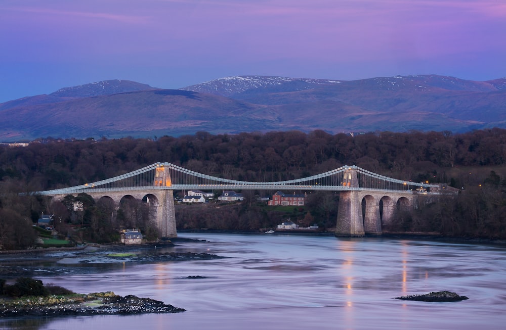 landscape photography of cable bridge near mountain range