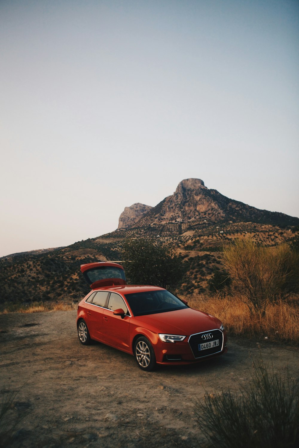 red Audi 5-door hatchback near mountain