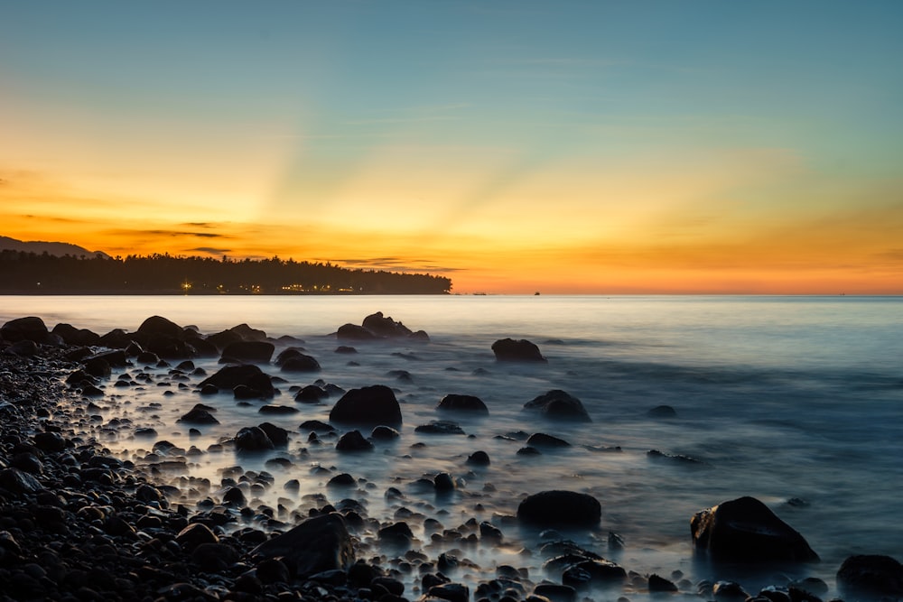 rocky seashore with calm body of water