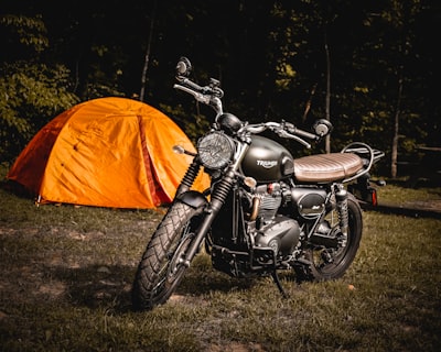 tent and motorcycle out in the woods