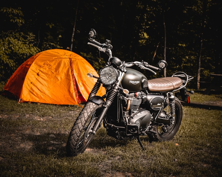 A classic brown naked motorcycle in warm sunlight, standing in for the rust-tanked Triton 650