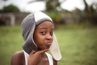 boy holding his chin standing on grass field equatorial guinea teams background