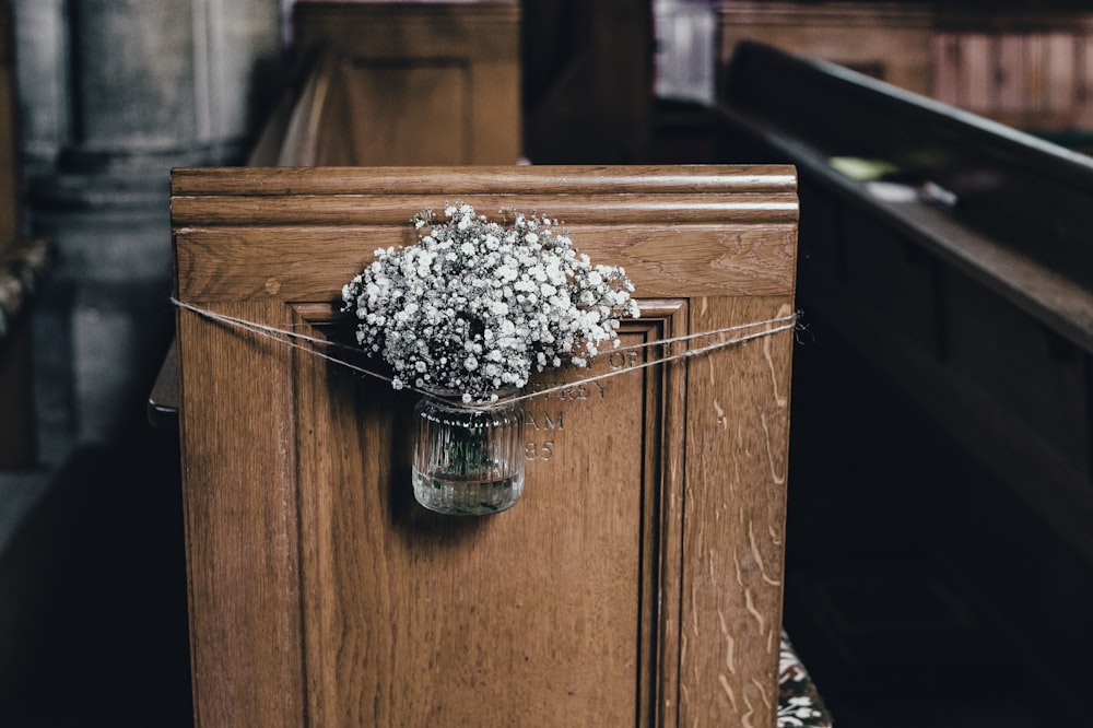 brown wooden bench with gray flowers