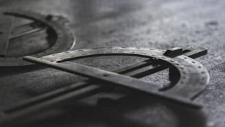 Detailed shot of metal sheets being measured and inspected under factory lights