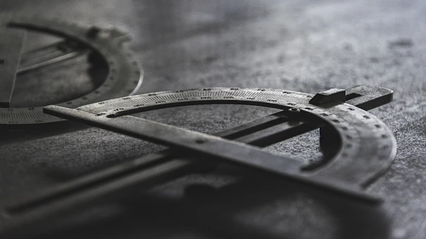 Detailed shot of metal sheets being measured and inspected under factory lights